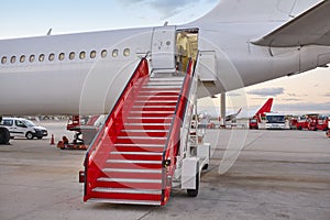 Airport runaway with airplane and stairway. Travel background.