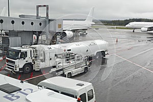 Airport runaway with airplanes on a rainy day. Travel