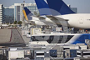 Airport runaway traffic with aeroplanes and cargo vehicles. Terminal