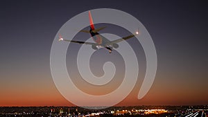 Airport runway lights at night, plane or airline landing to airstrip at sunset.