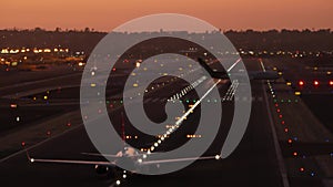 Airport runway lights at night, plane or airline taking off, airstrip at sunset.