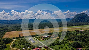 Airport runway at Mulu village near tropical forest and mountains near Gunung Mulu national park. Borneo. Sarawak.