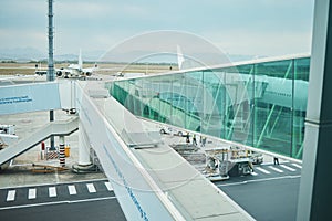 Airport, runway and platform of airplane trip, travel and transportation of airline gateway. Hangar, boarding tunnel and