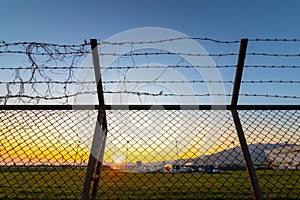 Airport security fence at  sunset