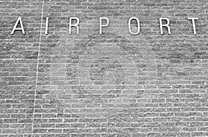 Airport sign on a brick background