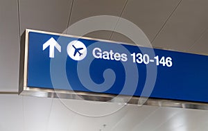 Airport sign showing direction to gate.