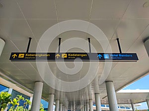 Airport signboard in Indonesia. Departures direction signboard