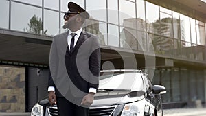 Airport taxi driver waiting for client arrival, transfer service at luxury hotel