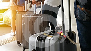 Airport taxi. passenger with big roller luggage standing on the line waiting for taxi queue at taxi parking lot