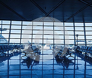 Airport terminal interior with rows of empty seats