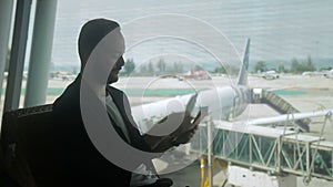 At the airport traveler checks tickets and passport at the window.