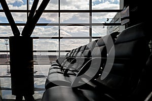 airport waiting area , seats and outside the window scene