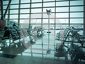 Airport waiting area , seats and outside the window scene