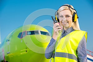 Airport worker with airplane on the background