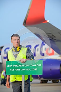Airport worker customs sign aircraft man male