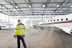 Airport workers check an aircraft for safety in a hangar