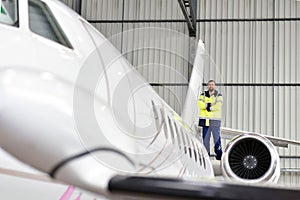 Airport workers check an aircraft for safety in a hangar