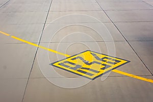 Airport yellow taxiway lines R36 markings on the apron on concrete asphalt, sign for airplane pilots