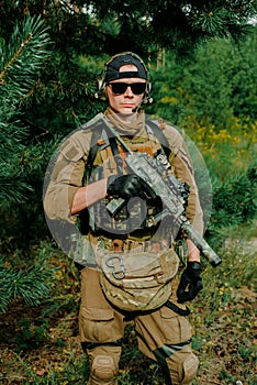 Airsoft man stand in amunition hold the gun