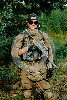 Airsoft man stand in amunition hold the gun photo