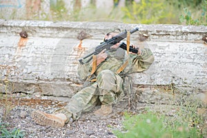 Airsoft player reloads his weapon during a firefight.