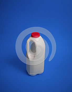 Airtight one gallon milk jug with a red cap.