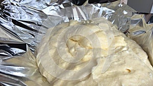 airy biscuit dough on foil slowly falling down dough foam making a pie or cake crust eggs flour and sugar all
