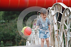 Aisa cute naughty lovely child girl play with balloon have fun outdoor in summer park happy smile happiness funny childhood