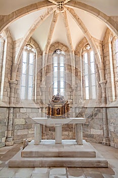 The aisle, altar and a gilded baroque tabernacle in the medieval church of Santa Cruz.