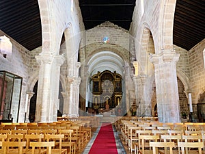 Aisle with rows of empty chairs in a church. Portugal.