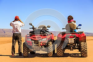 Ait Saoun, Morocco - February 22, 2016: Couple sitting in buggy car in desert