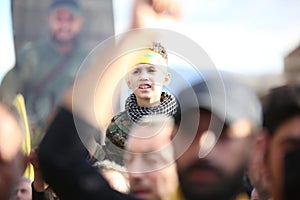 Hezbollah`s child supporter Carries the flag of Hezbollah