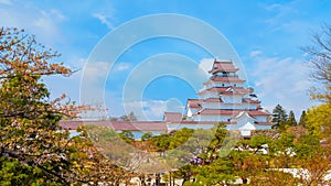 Aizu-Wakamatsu Castle with cherry blossom in Fukushima, Japan