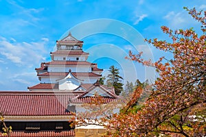 Aizuwakamatsu Castle with cherry blossom in Fukushima, Japan