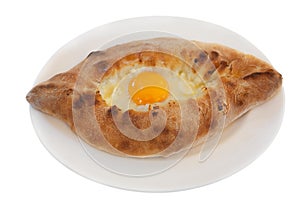 Ajarian khachapuri on dish isolated on white