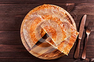 Ajarian Khachapuri traditional Georgian cheese pastry on cutting board.
