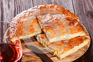 Ajarian Khachapuri traditional Georgian cheese pastry on cutting board. Homemade baking.