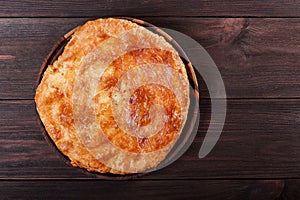 Ajarian Khachapuri traditional Georgian cheese pastry on cutting board. Homemade baking. Top view.