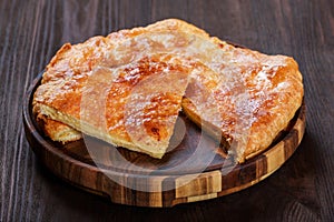 Ajarian Khachapuri traditional Georgian cheese pastry on cutting board. Homemade baking. Top view.