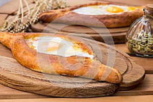 Ajarian khachapuri on wooden table. Traditional Georgian cuisine. cuisine of the Georgian people