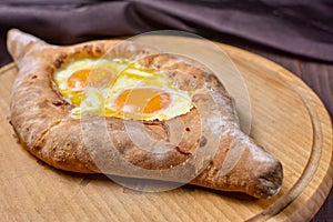 Ajarian traditional flatbread - khachapuri or hachapuri with egg and cheese. Copy text area for menu design or recipe book text