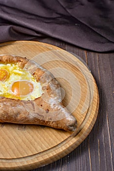 Ajarian traditional flatbread - khachapuri or hachapuri with egg and cheese. Copy text area for menu design or recipe book text