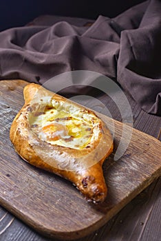 Ajarian traditional flatbread - khachapuri or hachapuri with egg and cheese. Copy text area for menu design or recipe book text