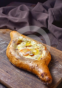 Ajarian traditional flatbread - khachapuri or hachapuri with egg and cheese. Copy text area for menu design or recipe book text