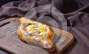 Ajarian traditional flatbread - khachapuri or hachapuri with egg and cheese. Copy text area for menu design or recipe book text