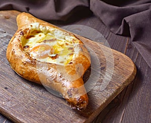 Ajarian traditional flatbread - khachapuri or hachapuri with egg and cheese. Copy text area for menu design or recipe book text