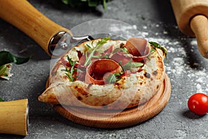 Ajarian traditional flatbread - khachapuri or hachapuri with with jamon, cheese and herbs