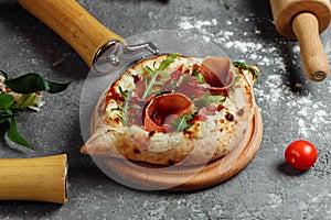Ajarian traditional flatbread - khachapuri or hachapuri with with jamon, cheese and herbs
