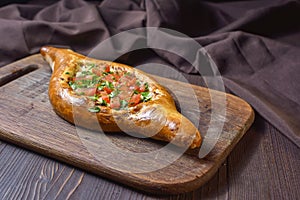 Ajarian traditional flatbread - khachapuri or hachapuri with meat and vegetables and cheese. Copy text area for menu design or