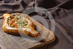 Ajarian traditional flatbread - khachapuri or hachapuri with meat and vegetables and cheese. Copy text area for menu design or